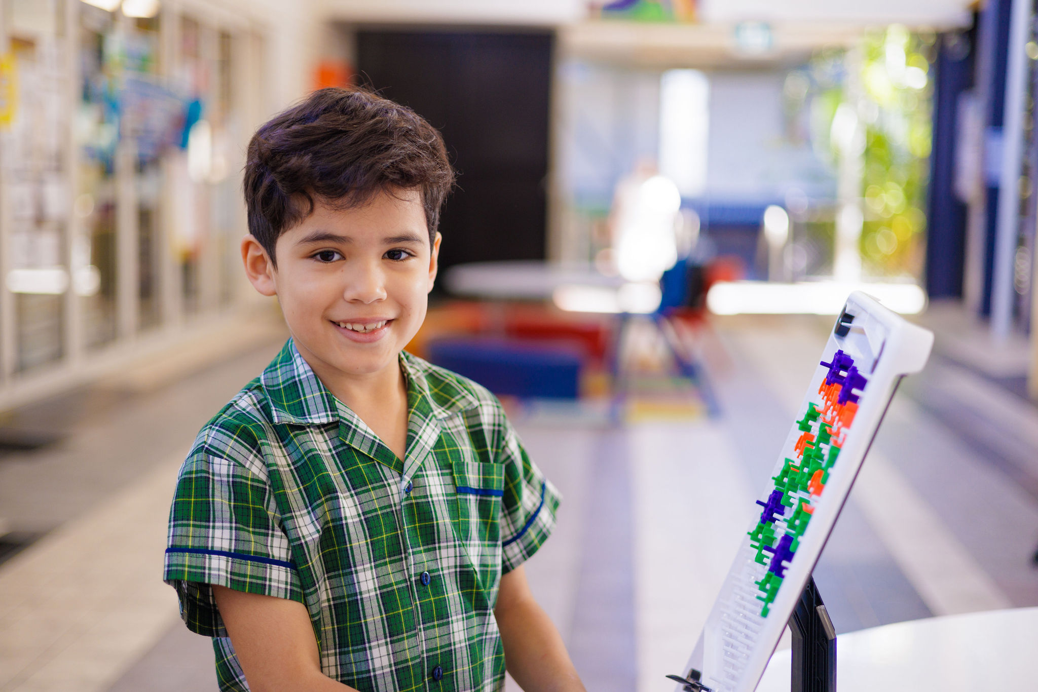 Student using hands‑on learning materials in a school learning space, highlighting problem solving, curiosity and active learning
