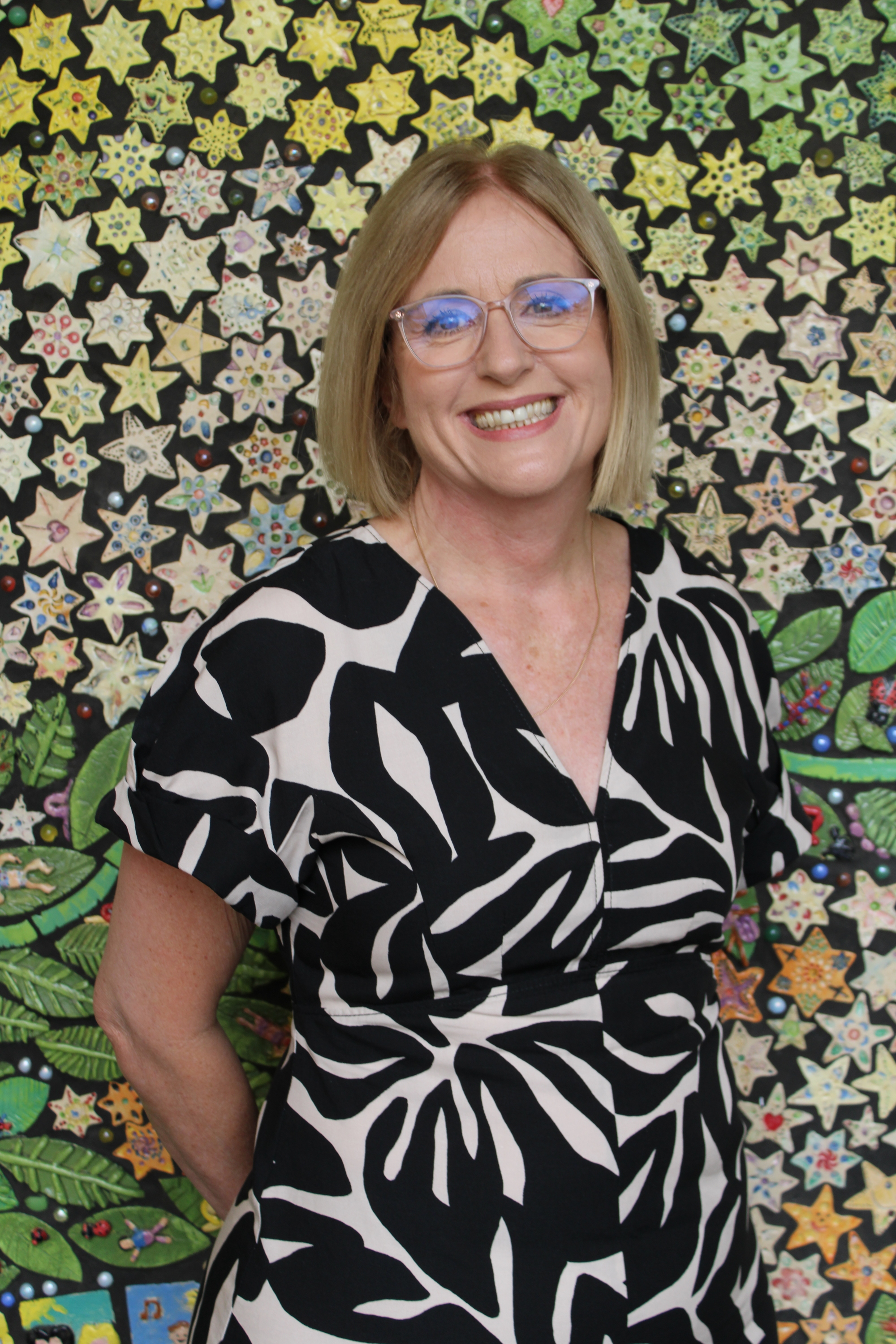 Theresa Redgwell, Principal, standing on school grounds, representing school leadership, approachability and connection with the school community